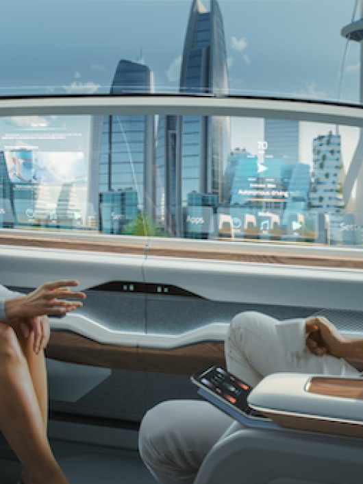 Beautiful Female and Senior Man are Having a Conversation in a Driverless Autonomous Vehicle. Futuristic Self-Driving Van is Moving on a Public Highway in a Modern City with Glass Skyscrapers.